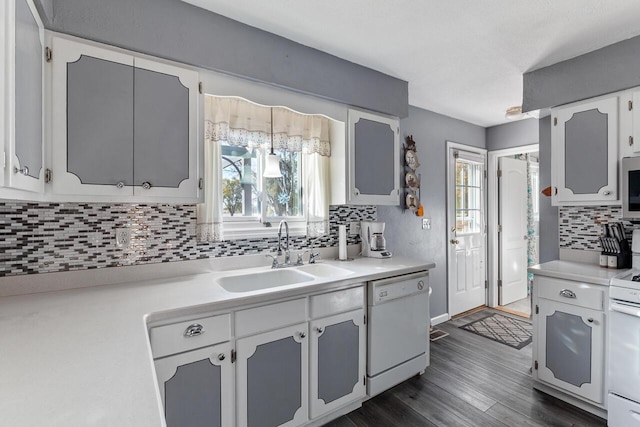 kitchen featuring white cabinetry, sink, a healthy amount of sunlight, and white appliances