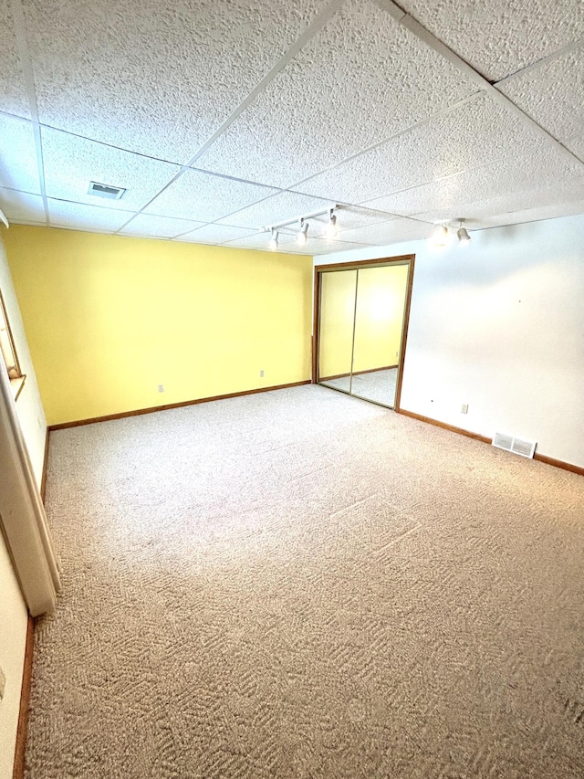 spare room featuring carpet floors and track lighting