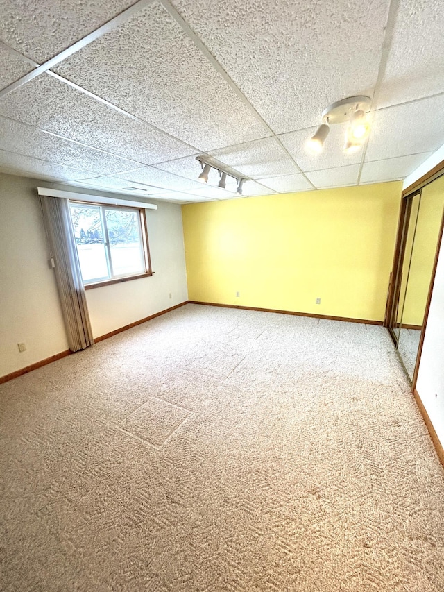 carpeted spare room with track lighting