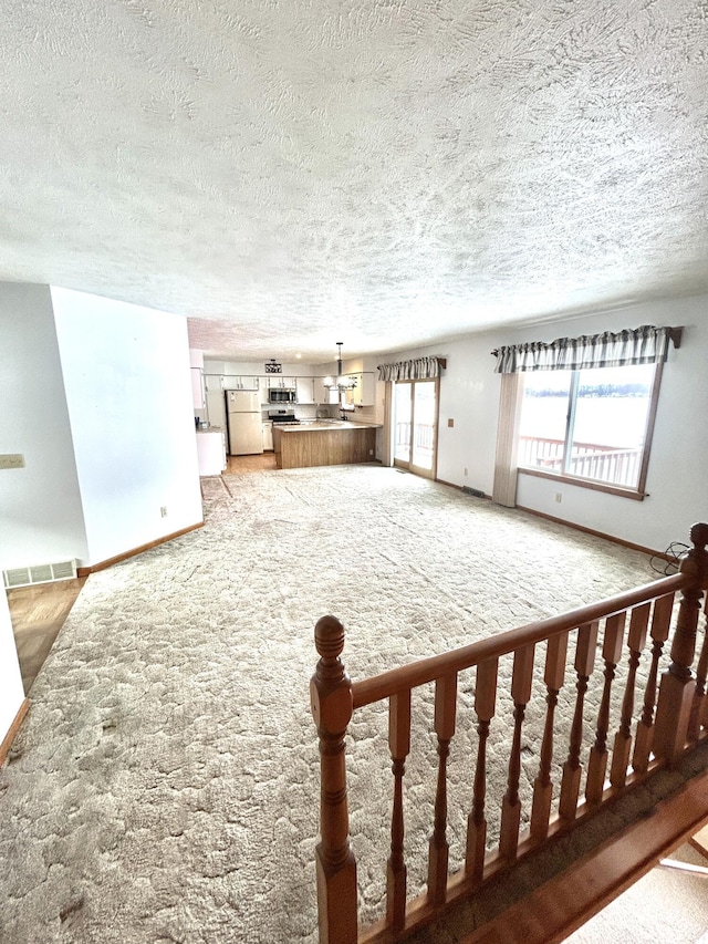 unfurnished living room featuring carpet flooring