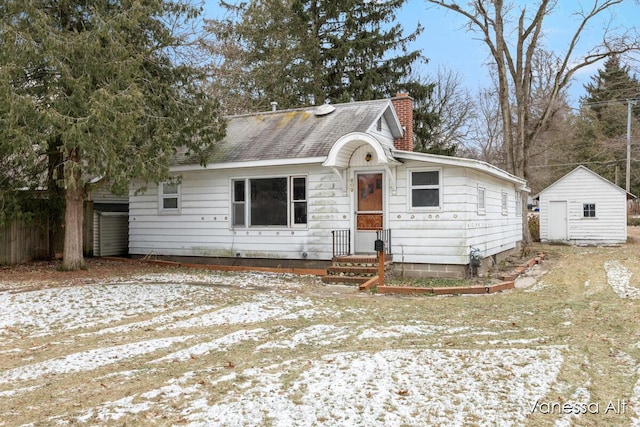 view of front of house featuring a storage shed