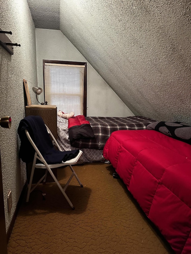 carpeted bedroom featuring a textured ceiling and lofted ceiling