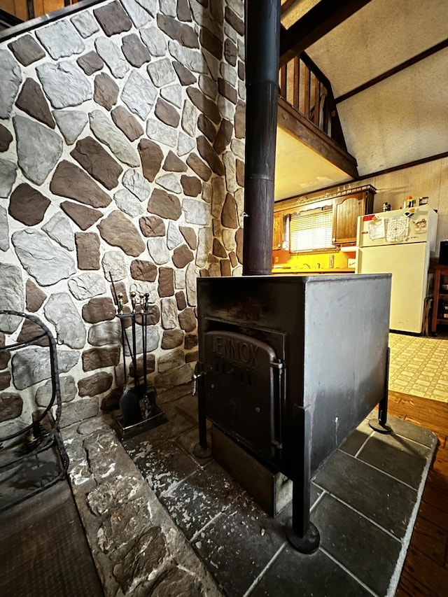 interior details featuring white refrigerator and a wood stove