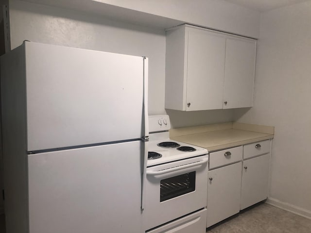 kitchen featuring white cabinets and white appliances