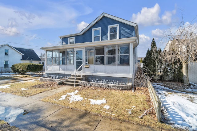 view of front of house featuring a sunroom