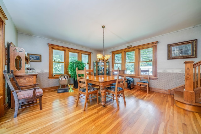 dining area with a chandelier and light wood-type flooring