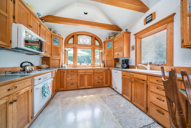 kitchen featuring white appliances, lofted ceiling with beams, a healthy amount of sunlight, and sink