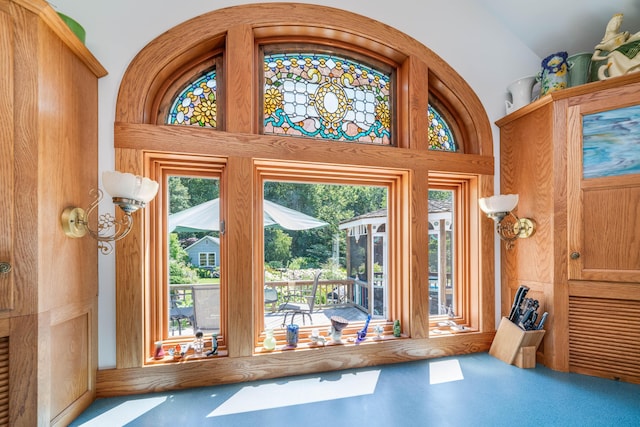 doorway to outside with a towering ceiling