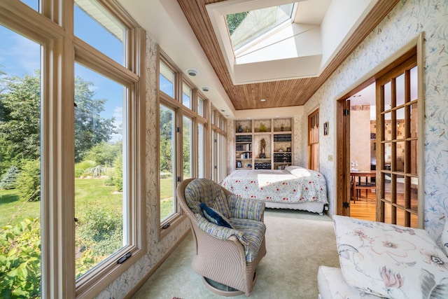 sunroom / solarium featuring a skylight, a wealth of natural light, and wooden ceiling