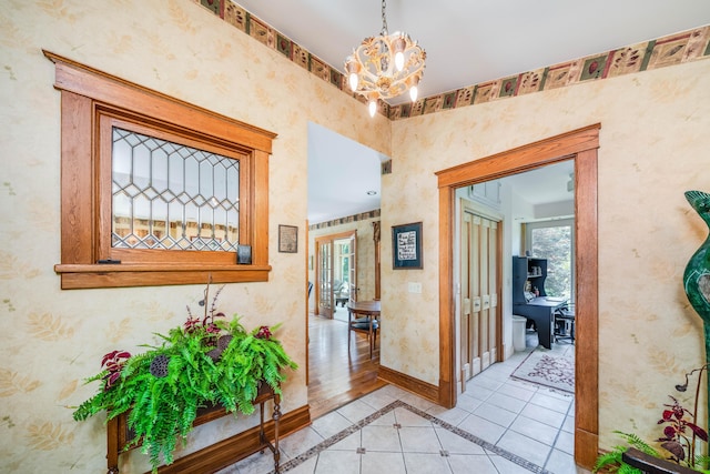 hall with light tile patterned floors and a notable chandelier