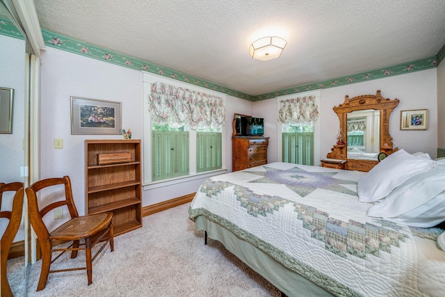 carpeted bedroom with a textured ceiling