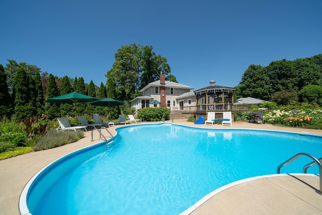 view of swimming pool with a gazebo, a deck, and a patio area