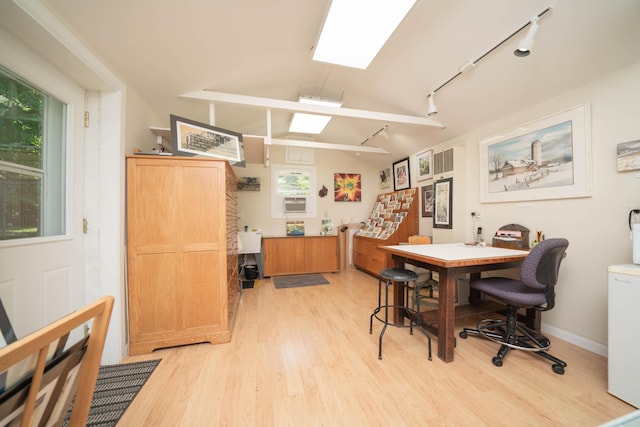 office featuring light hardwood / wood-style floors and vaulted ceiling