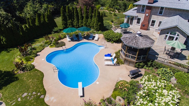 view of swimming pool with a gazebo, a patio area, and a diving board