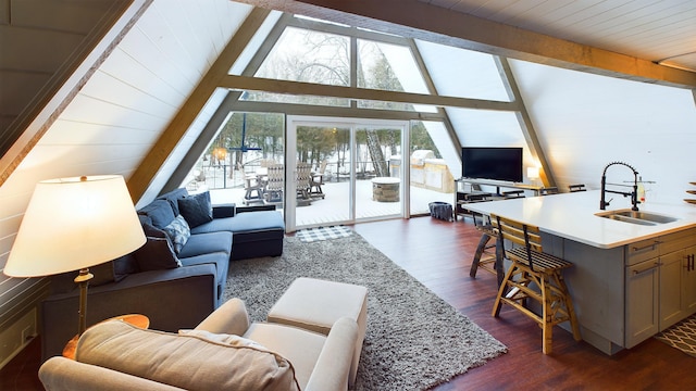 living room with vaulted ceiling with beams, dark wood-type flooring, and sink