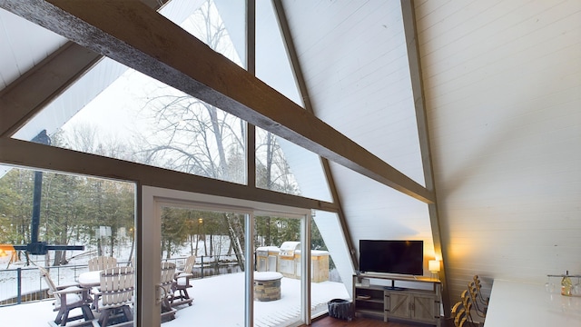 living room with beam ceiling and high vaulted ceiling