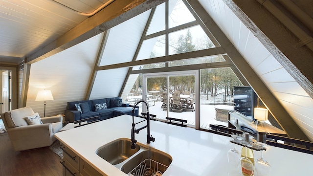 kitchen featuring hardwood / wood-style floors, lofted ceiling with beams, and sink