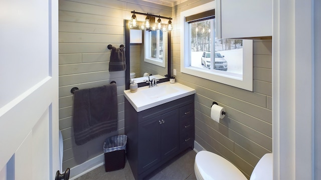 bathroom featuring tile patterned floors, vanity, and toilet