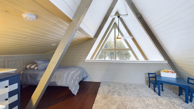 bedroom featuring vaulted ceiling with beams, wooden walls, carpet, and wooden ceiling