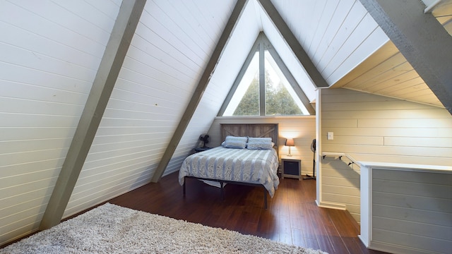 bedroom with wood walls, dark hardwood / wood-style floors, and lofted ceiling