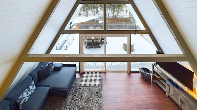 sunroom / solarium featuring lofted ceiling with beams