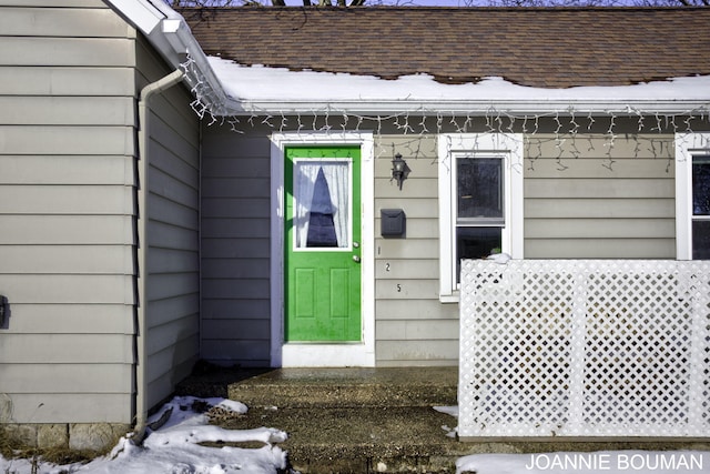 view of snow covered property entrance