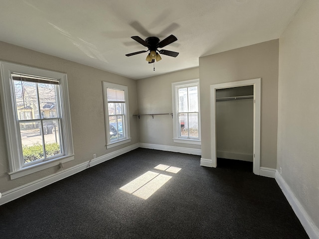 unfurnished bedroom with ceiling fan and a closet