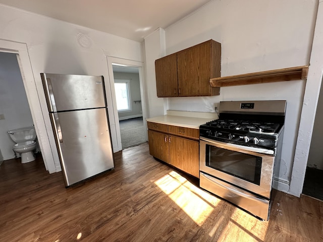 kitchen featuring appliances with stainless steel finishes and dark hardwood / wood-style flooring