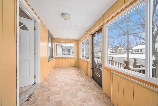 unfurnished sunroom with plenty of natural light