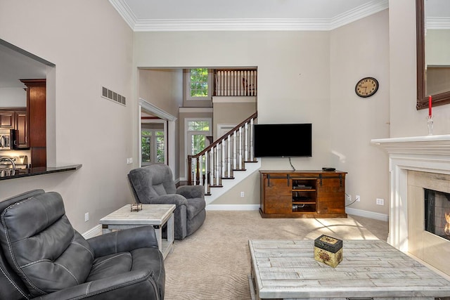 carpeted living room featuring ornamental molding and a fireplace