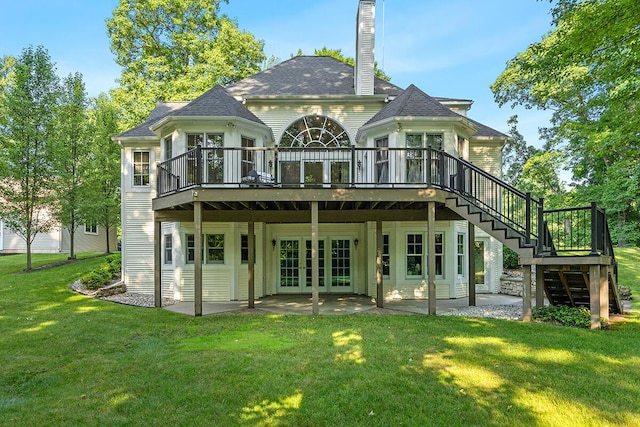 back of property featuring a patio area, a deck, a yard, and french doors