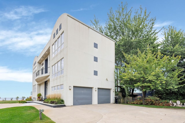 view of home's exterior with a balcony and a garage