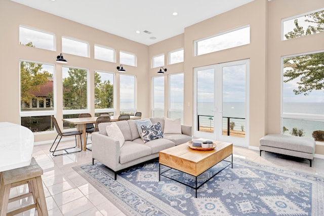 sunroom / solarium featuring a water view and a wealth of natural light