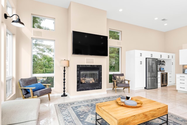 living room with a high ceiling and beverage cooler