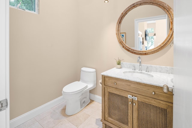 bathroom featuring tile patterned flooring, vanity, and toilet