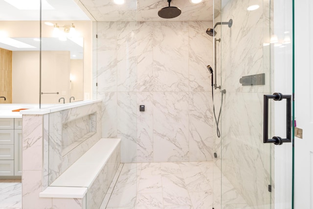 bathroom with a shower with door and vanity