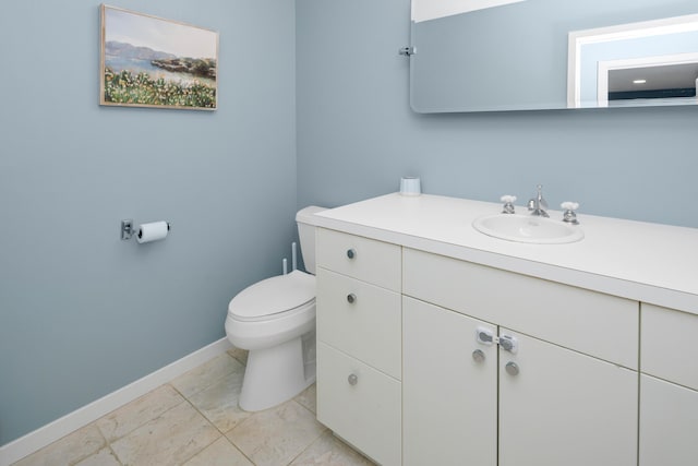 bathroom featuring tile patterned flooring, vanity, and toilet