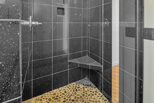 bathroom with tiled shower