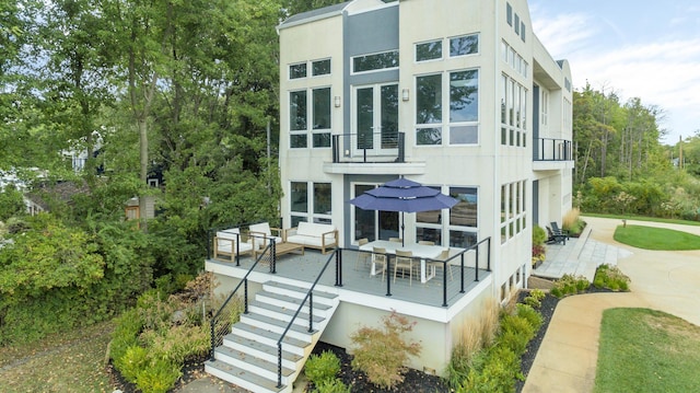 exterior space with outdoor lounge area, a patio area, and a balcony