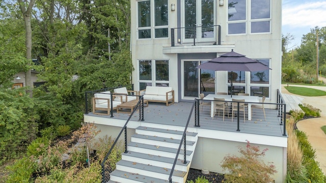 exterior space with a balcony, an outdoor hangout area, and a deck