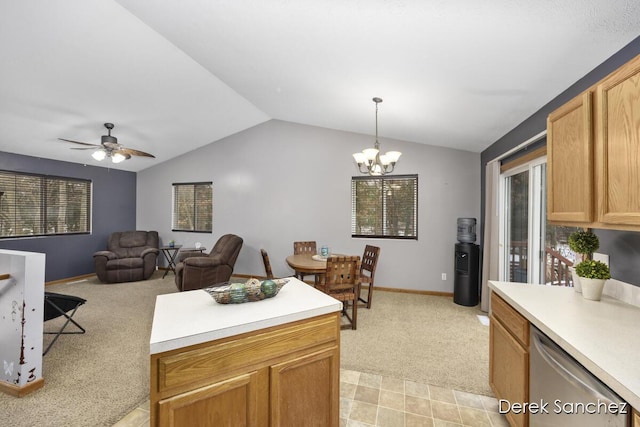 kitchen with lofted ceiling, ceiling fan with notable chandelier, stainless steel dishwasher, decorative light fixtures, and light colored carpet