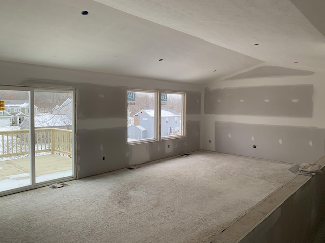 unfurnished living room with lofted ceiling