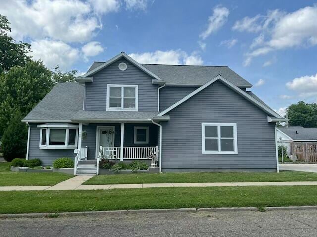 view of front facade featuring covered porch and a front yard