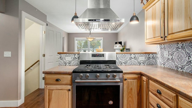 kitchen with dark hardwood / wood-style flooring, backsplash, stainless steel gas range oven, extractor fan, and pendant lighting