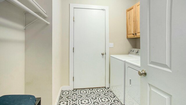 laundry area featuring cabinets, washer and clothes dryer, and light tile patterned flooring