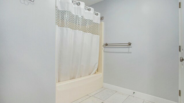 bathroom featuring tile patterned floors and shower / bathtub combination with curtain