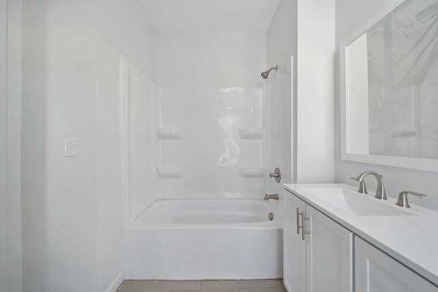 bathroom with tile patterned floors, vanity, and washtub / shower combination