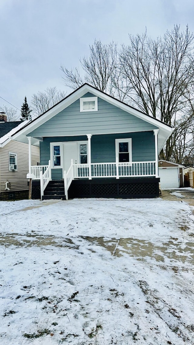 bungalow-style home with a porch and a garage