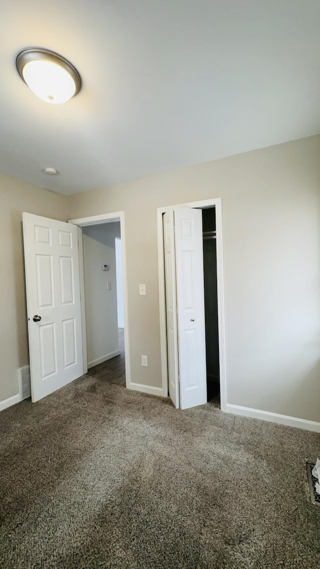 unfurnished bedroom with carpet floors