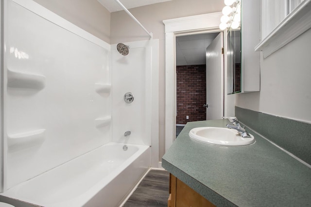 bathroom with bathing tub / shower combination, vanity, and wood-type flooring